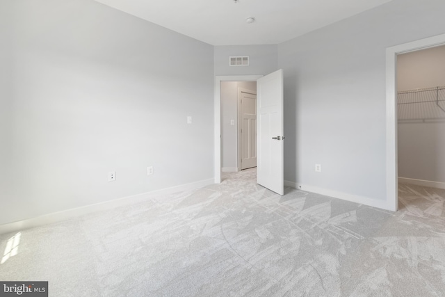 14438 Mattawoman Dr Unit 5000H, Brandywine, MD 20613 - unfurnished bedroom featuring light carpet, a spacious closet, and baseboards