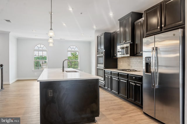 14438 Mattawoman Dr Unit 5000H, Brandywine, MD 20613 - kitchen featuring stainless steel appliances, a sink, light countertops, light wood-type flooring, and backsplash
