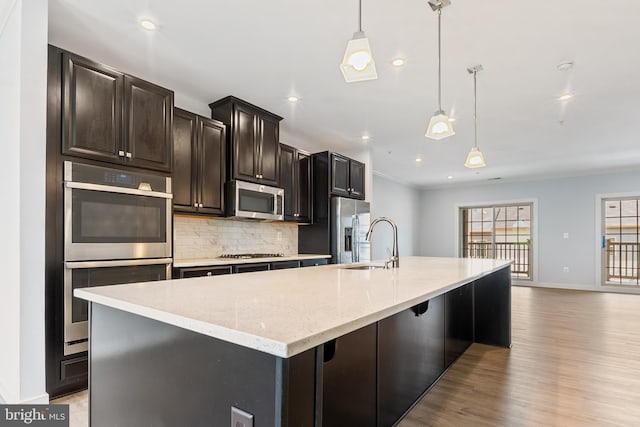 14438 Mattawoman Dr Unit 5000H, Brandywine, MD 20613 - kitchen with stainless steel appliances, tasteful backsplash, baseboards, light wood-style flooring, and a large island with sink
