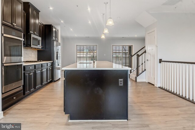 14438 Mattawoman Dr Unit 5000H, Brandywine, MD 20613 - kitchen featuring appliances with stainless steel finishes, a sink, light wood-type flooring, an island with sink, and recessed lighting