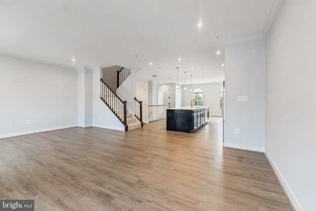 14438 Mattawoman Dr Unit 5000H, Brandywine, MD 20613 - unfurnished living room with a sink, ornamental molding, stairway, recessed lighting, and light wood-type flooring