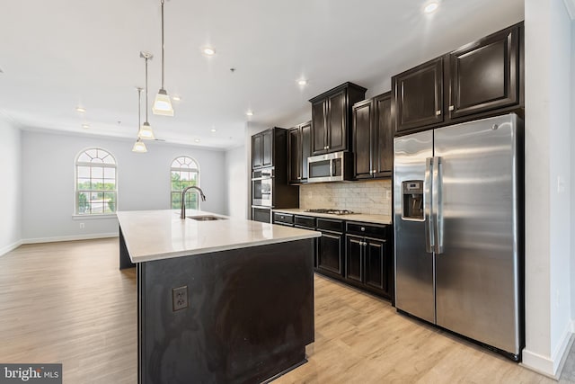 14438 Mattawoman Dr Unit 5000H, Brandywine, MD 20613 - kitchen with appliances with stainless steel finishes, a sink, light countertops, light wood-style floors, and a kitchen island with sink