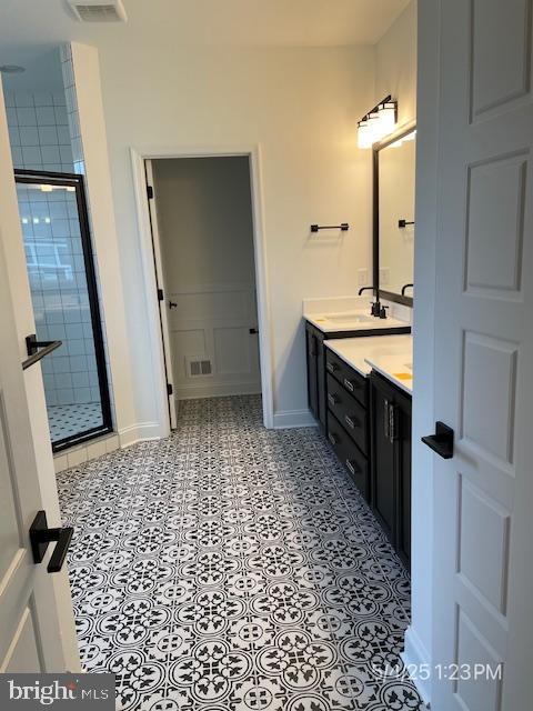 31123 Surfbird Way, Millsboro, DE 19966 - bathroom featuring double vanity, baseboards, and a stall shower