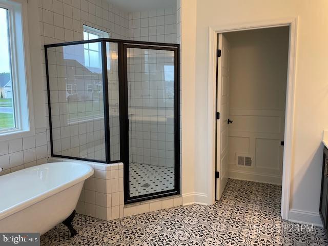 31123 Surfbird Way, Millsboro, DE 19966 - bathroom with a stall shower, a freestanding tub, and vanity