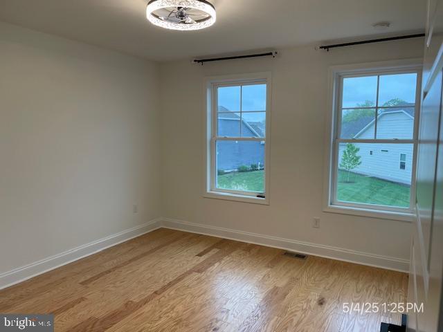 31123 Surfbird Way, Millsboro, DE 19966 - unfurnished room featuring wood finished floors, baseboards, and healthy amount of natural light