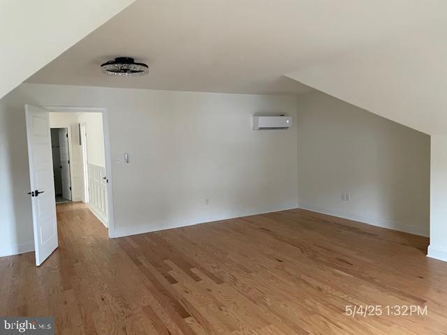31123 Surfbird Way, Millsboro, DE 19966 - bonus room featuring an AC wall unit, wood finished floors, and baseboards