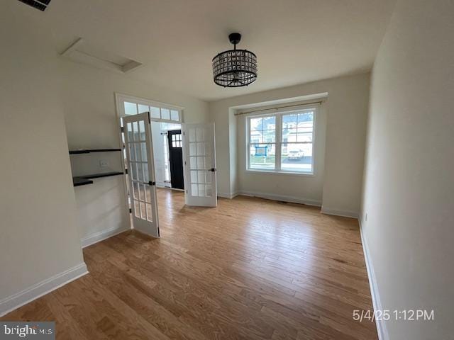 31123 Surfbird Way, Millsboro, DE 19966 - unfurnished dining area featuring wood finished floors, baseboards, and french doors