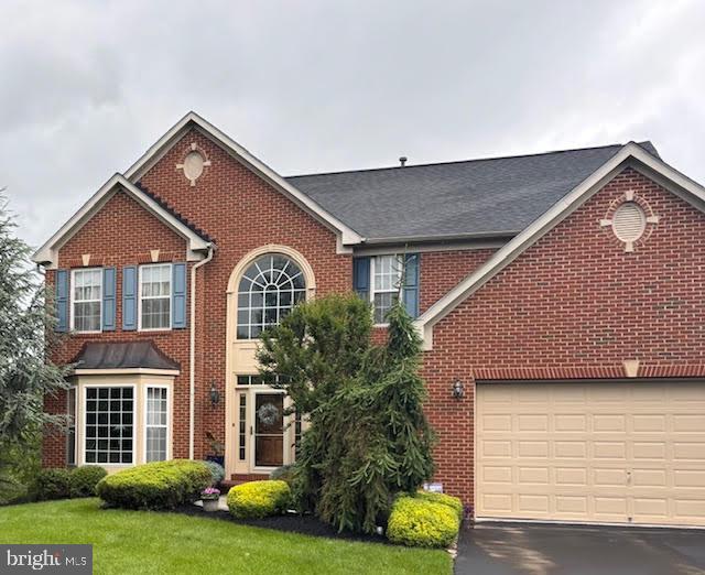 114 Fawn Hill Rd, Hanover, PA 17331 - view of front of house with brick siding, asphalt driveway, and a front yard