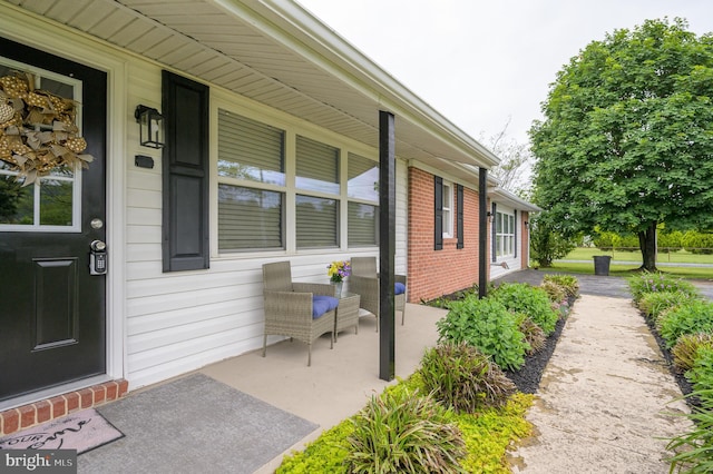 1267 Dominion Rd, Gerrardstown, WV 25420 - view of exterior entry with covered porch and brick siding