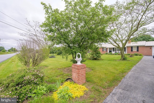 1267 Dominion Rd, Gerrardstown, WV 25420 - view of front of home featuring a front yard, a chimney, and brick siding
