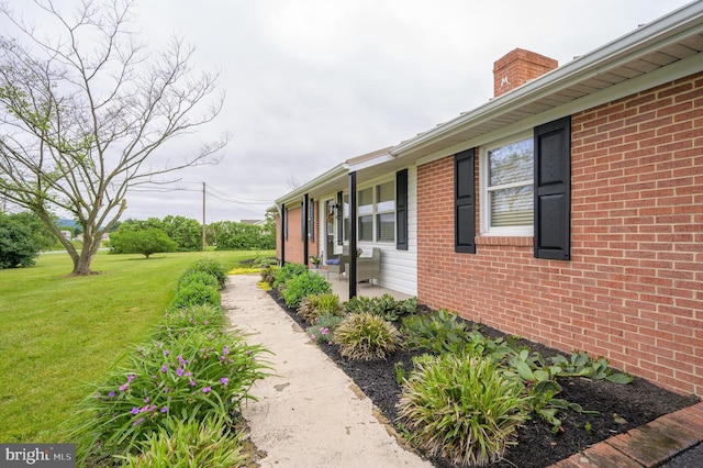 1267 Dominion Rd, Gerrardstown, WV 25420 - view of side of home with a yard, brick siding, and a chimney