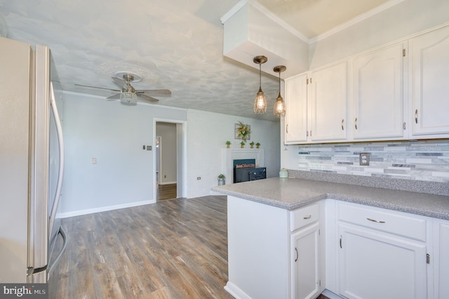 1267 Dominion Rd, Gerrardstown, WV 25420 - kitchen featuring freestanding refrigerator, white cabinetry, decorative backsplash, open floor plan, and crown molding
