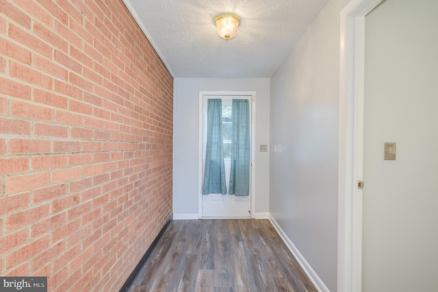 1267 Dominion Rd, Gerrardstown, WV 25420 - hallway featuring brick wall, a textured ceiling, dark wood-type flooring, and baseboards