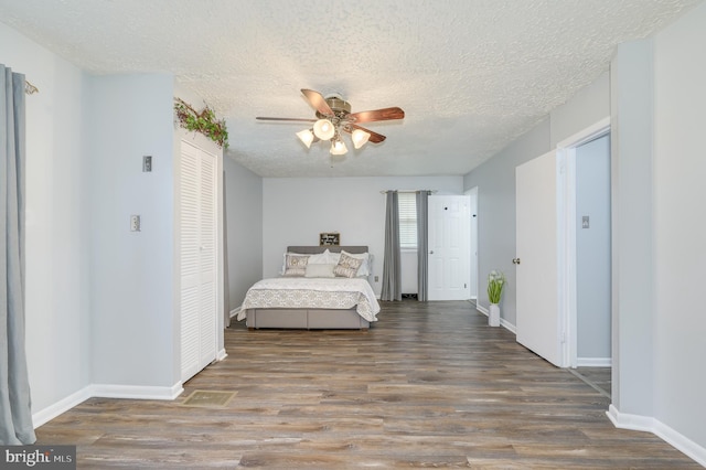1267 Dominion Rd, Gerrardstown, WV 25420 - bedroom featuring wood finished floors, a textured ceiling, baseboards, and a closet