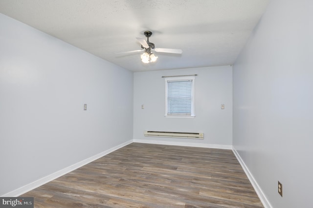 1267 Dominion Rd, Gerrardstown, WV 25420 - spare room with a baseboard radiator, ceiling fan, wood finished floors, and baseboards