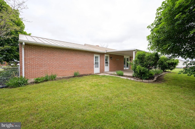 1267 Dominion Rd, Gerrardstown, WV 25420 - rear view of property featuring a standing seam roof, brick siding, a patio area, and metal roof