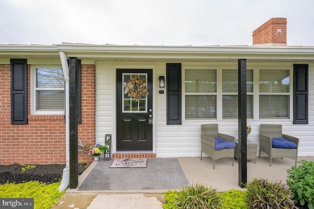 1267 Dominion Rd, Gerrardstown, WV 25420 - property entrance featuring brick siding, a porch, and a chimney