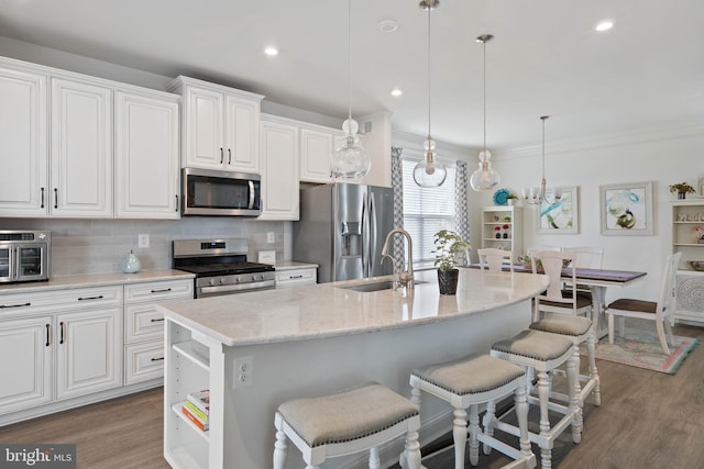 20093 Old Salt Ln, Frankford, DE 19945 - kitchen with appliances with stainless steel finishes, a sink, a kitchen breakfast bar, backsplash, and white cabinetry