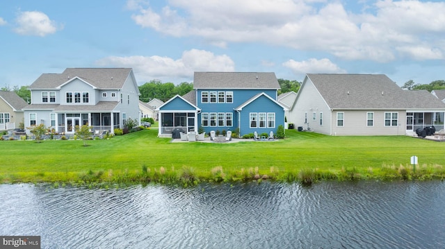 20093 Old Salt Ln, Frankford, DE 19945 - back of property featuring a sunroom, a water view, a lawn, and a patio area