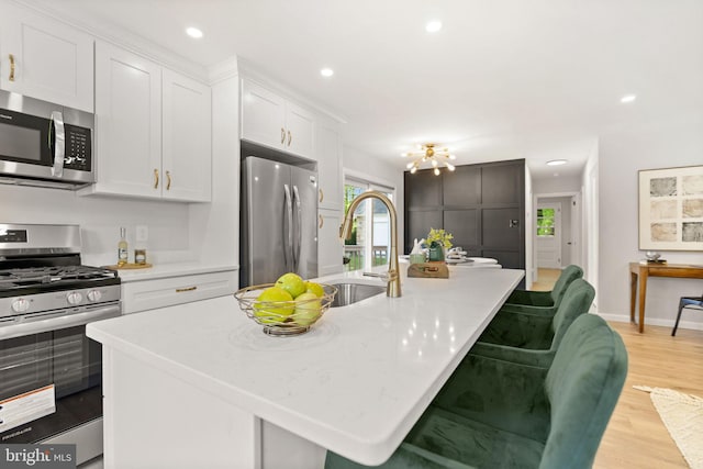 112 Morris Ave, Woodlyn, PA 19094 - kitchen featuring appliances with stainless steel finishes, a sink, a center island with sink, white cabinets, and recessed lighting