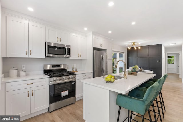 112 Morris Ave, Woodlyn, PA 19094 - kitchen with appliances with stainless steel finishes, healthy amount of natural light, white cabinetry, light wood-style flooring, and recessed lighting