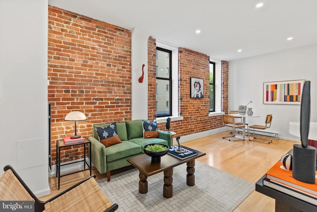1615 Q St NW Unit 214, Washington, DC 20009 - living room with recessed lighting, wood finished floors, and brick wall