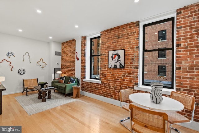 1615 Q St NW Unit 214, Washington, DC 20009 - living room featuring wood finished floors, recessed lighting, and brick wall
