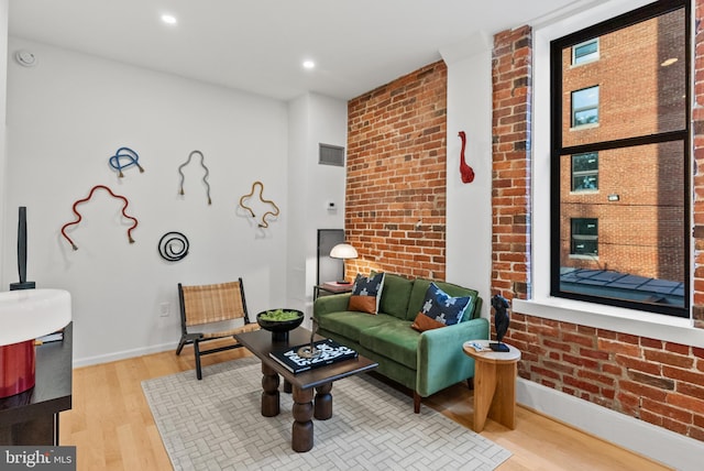 1615 Q St NW Unit 214, Washington, DC 20009 - living room featuring light wood-type flooring, brick wall, and recessed lighting