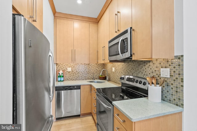 1615 Q St NW Unit 214, Washington, DC 20009 - kitchen with appliances with stainless steel finishes, tasteful backsplash, light stone countertops, light brown cabinetry, and light wood-style flooring
