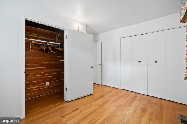 530 Anneslie Rd, Baltimore, MD 21212 - unfurnished bedroom with a closet, light wood-style floors, and wood walls