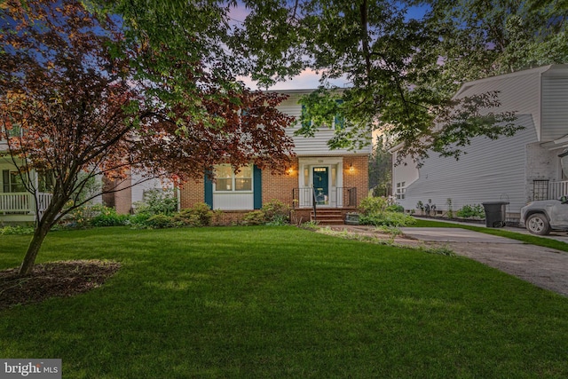 530 Anneslie Rd, Baltimore, MD 21212 - obstructed view of property featuring brick siding and a lawn