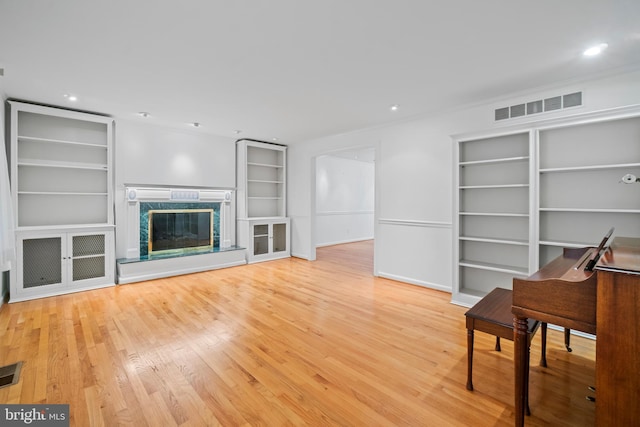 530 Anneslie Rd, Baltimore, MD 21212 - unfurnished living room with built in shelves, wood finished floors, recessed lighting, and a premium fireplace