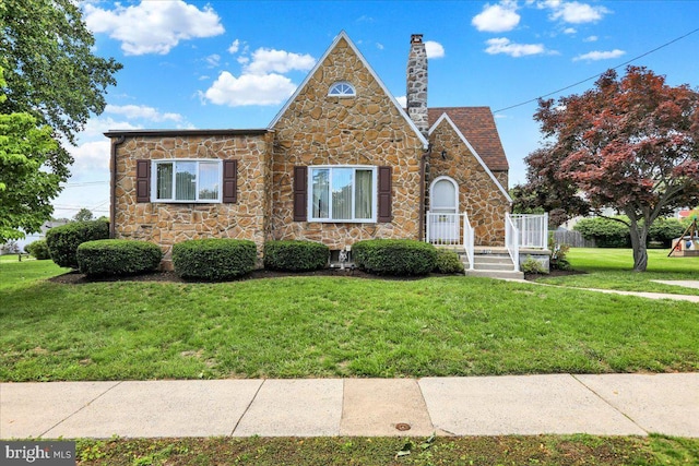 1807 King St, Reading, PA 19605 - english style home featuring stone siding, a front lawn, and a chimney