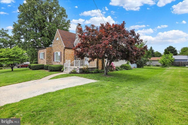 1807 King St, Reading, PA 19605 - view of front facade with stone siding, a front lawn, and a chimney