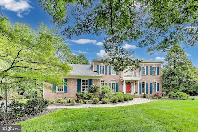 10106 Waterside Dr, Burke, VA 22015 - georgian-style home with brick siding, a front yard, and a balcony