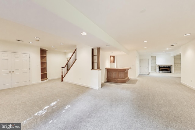 10106 Waterside Dr, Burke, VA 22015 - unfurnished living room with light carpet, recessed lighting, baseboards, stairs, and bar area