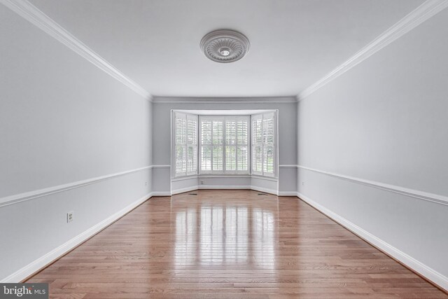 10106 Waterside Dr, Burke, VA 22015 - empty room with wood finished floors, crown molding, and baseboards