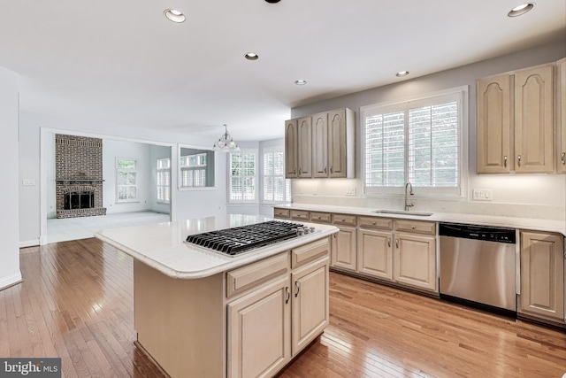 10106 Waterside Dr, Burke, VA 22015 - kitchen with stainless steel appliances, light wood-style flooring, a sink, light countertops, and a chandelier