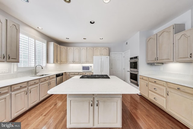 10106 Waterside Dr, Burke, VA 22015 - kitchen with appliances with stainless steel finishes, a sink, a kitchen island, light wood-style flooring, and recessed lighting