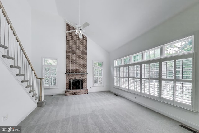 10106 Waterside Dr, Burke, VA 22015 - unfurnished living room with high vaulted ceiling, carpet floors, plenty of natural light, a brick fireplace, and a ceiling fan