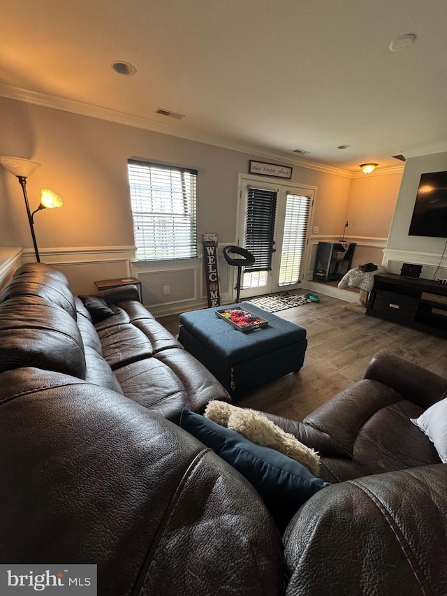23 Winding Rd, Levittown, PA 19057 - living room featuring ornamental molding, wood finished floors, and a wainscoted wall
