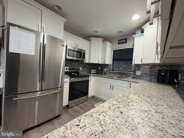 23 Winding Rd, Levittown, PA 19057 - kitchen featuring stainless steel appliances, a sink, dark wood-style floors, white cabinetry, and recessed lighting