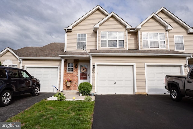 315 Dogwood St, Bally, PA 19503 - view of front of house featuring driveway, brick siding, and a garage