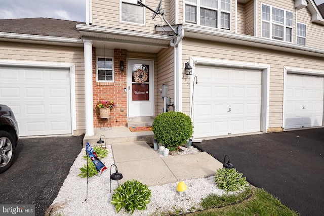 315 Dogwood St, Bally, PA 19503 - view of exterior entry with brick siding, a garage, and driveway