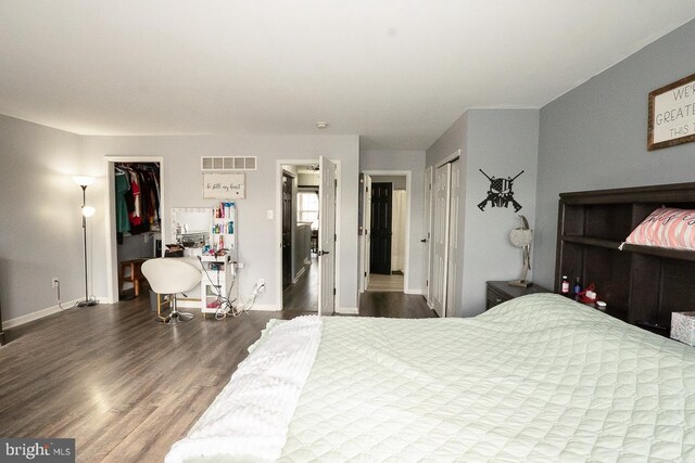 315 Dogwood St, Bally, PA 19503 - bedroom with wood finished floors, baseboards, a closet, and a walk in closet