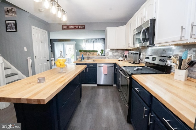 315 Dogwood St, Bally, PA 19503 - kitchen with wood counters, appliances with stainless steel finishes, white cabinets, and blue cabinetry