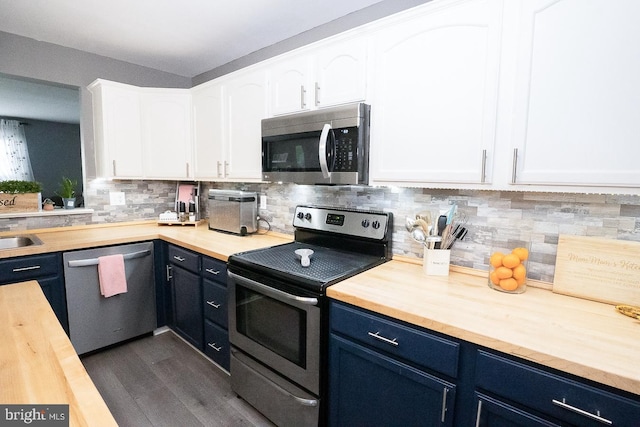315 Dogwood St, Bally, PA 19503 - kitchen with appliances with stainless steel finishes, wooden counters, blue cabinetry, white cabinets, and decorative backsplash