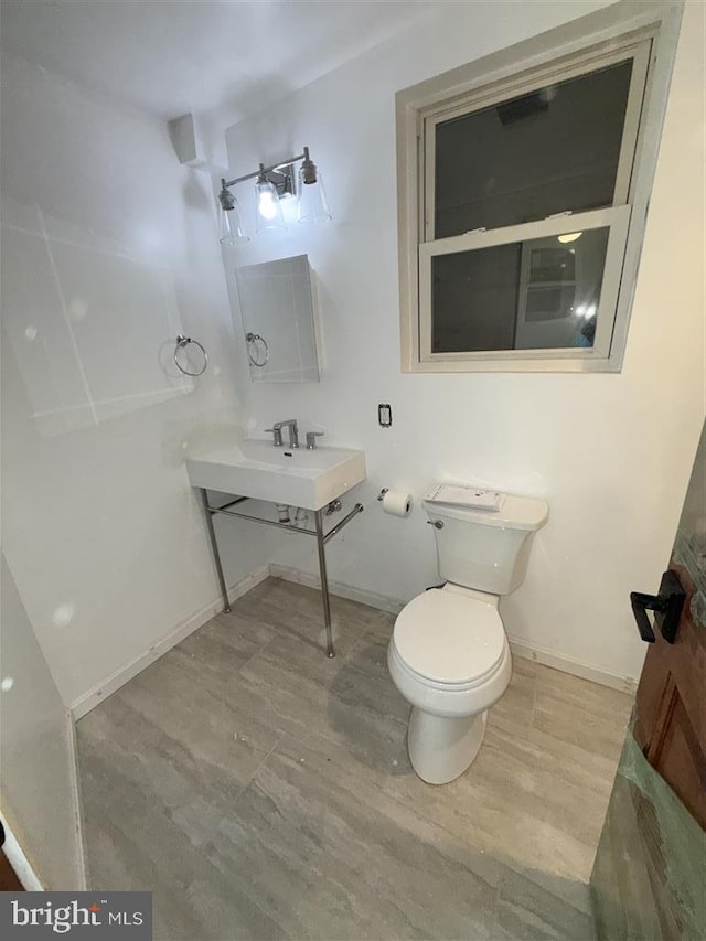 40 Bryant St NW, Washington, DC 20001 - bathroom with toilet, baseboards, wood finished floors, and a sink