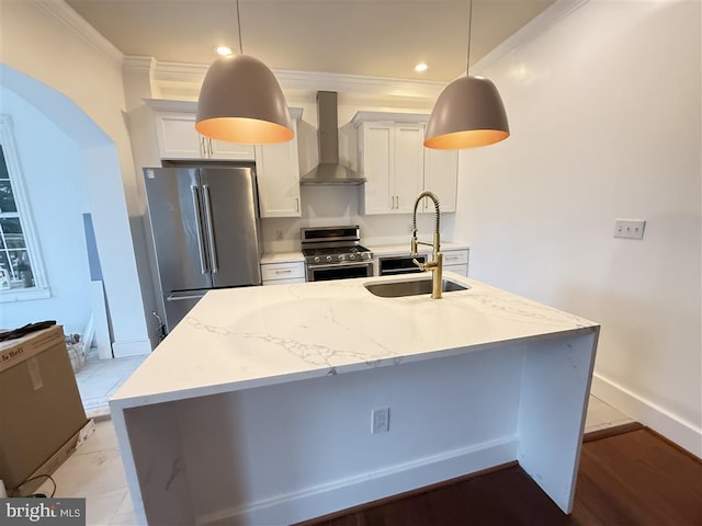 40 Bryant St NW, Washington, DC 20001 - kitchen with stainless steel appliances, wall chimney range hood, a sink, crown molding, and white cabinetry
