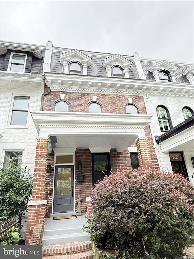 40 Bryant St NW, Washington, DC 20001 - view of exterior entry featuring mansard roof, brick siding, and a high end roof